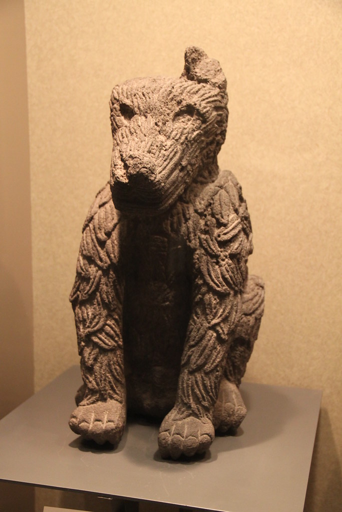 Stone carving of a feathered coyote