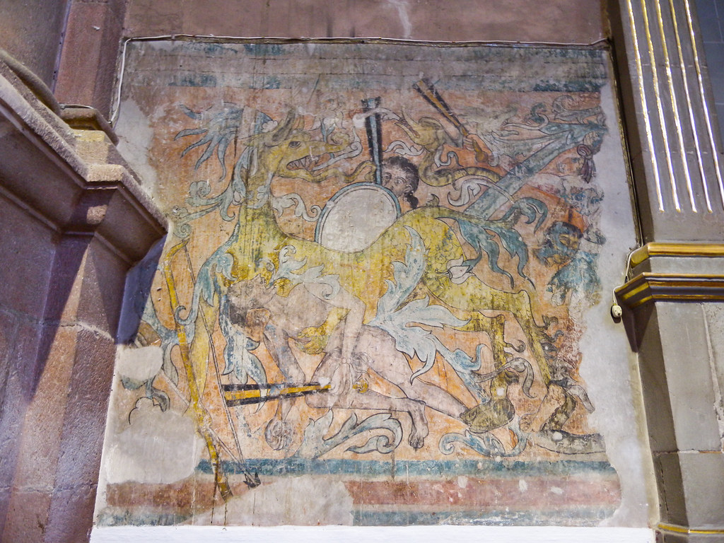 Mural of a large yellow horse with an Aztec knight
