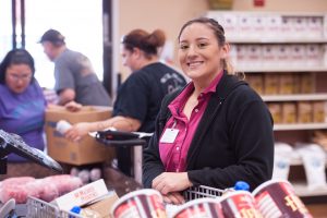Supermarket cashier smiling