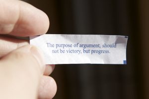 A fortune from a fortune cookie that says the purpose of argument is not victory but progress