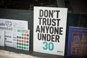 A sign that says "Don't trust anyone under 30"