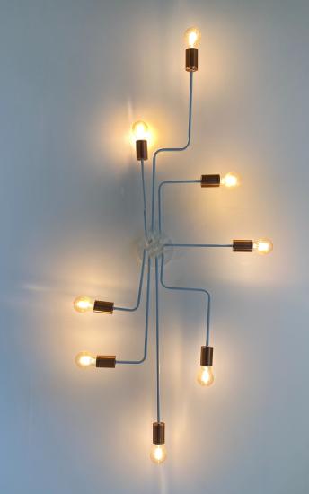 A light fixture with eight light bulbs, each connected to the others by a rod.