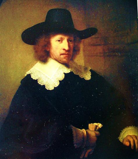 Painted man wearing a black hat and jacket while holding a glove in one hand