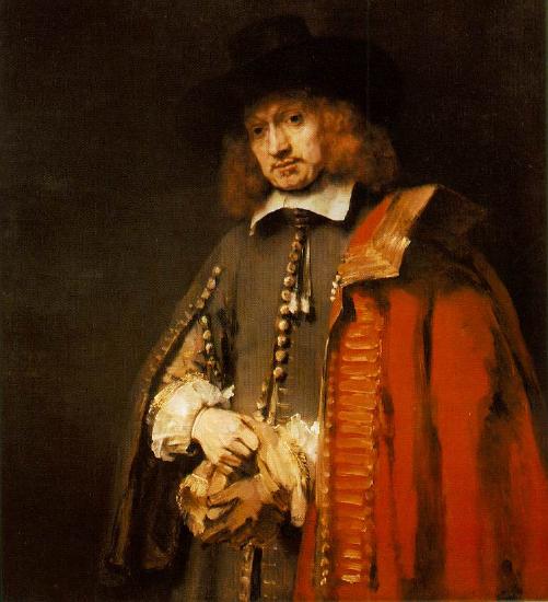 Man in red jacket and black hat putting on gloves