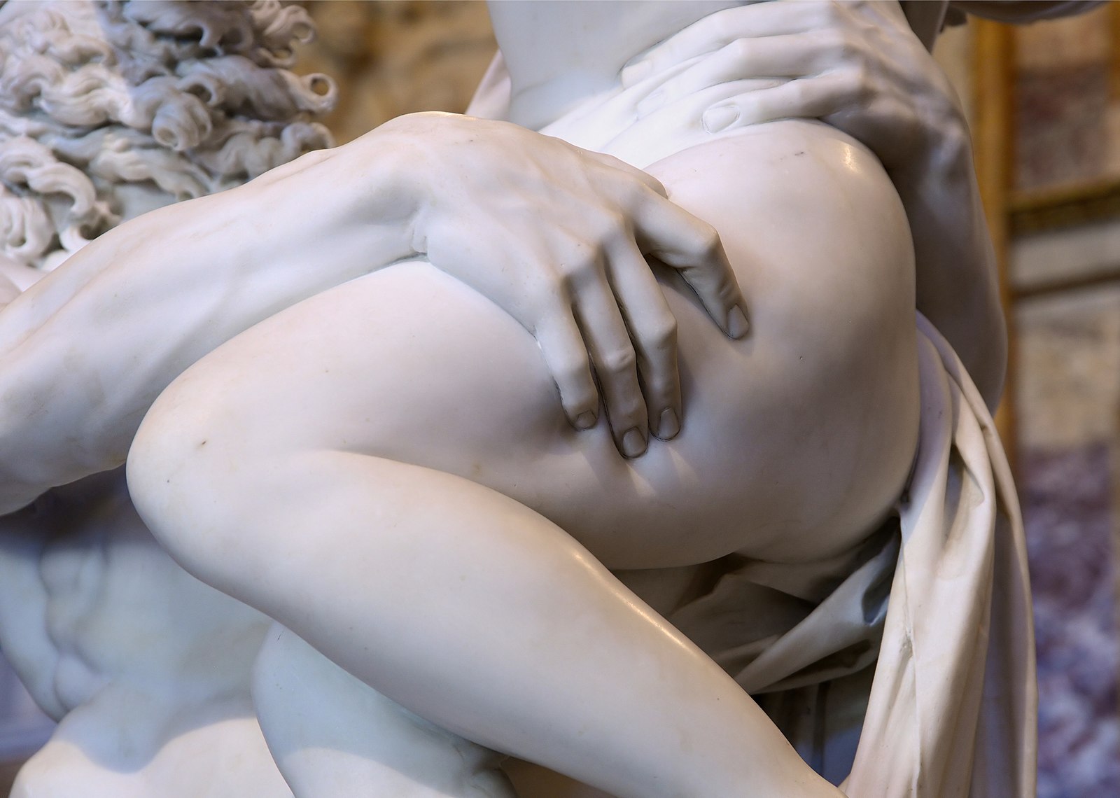 The rape of Proserpina a marble structure of a man and a woman close up