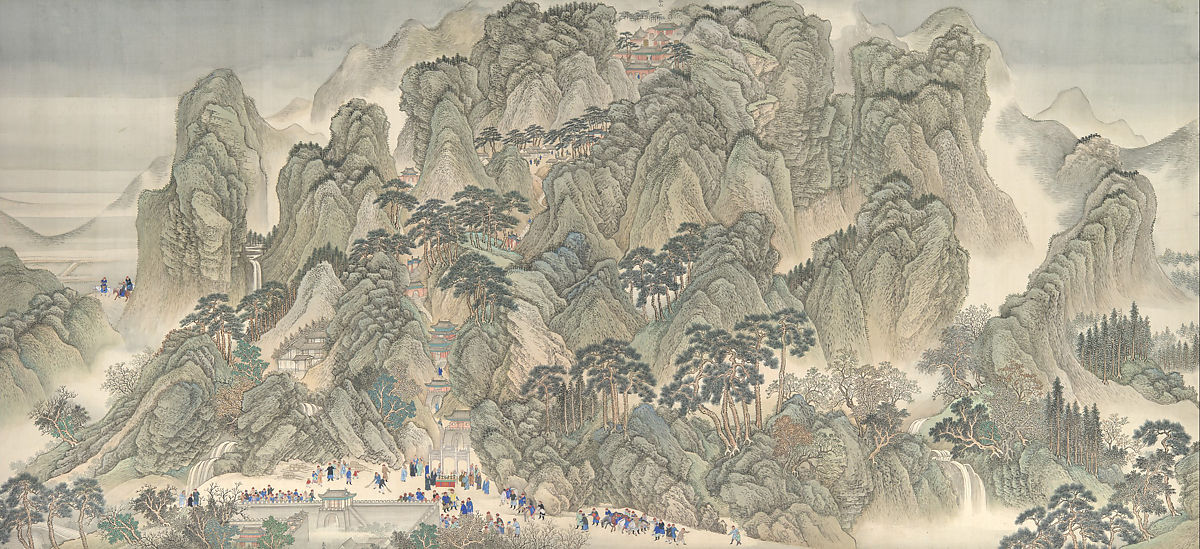 A mountainous scene with people in the valley
