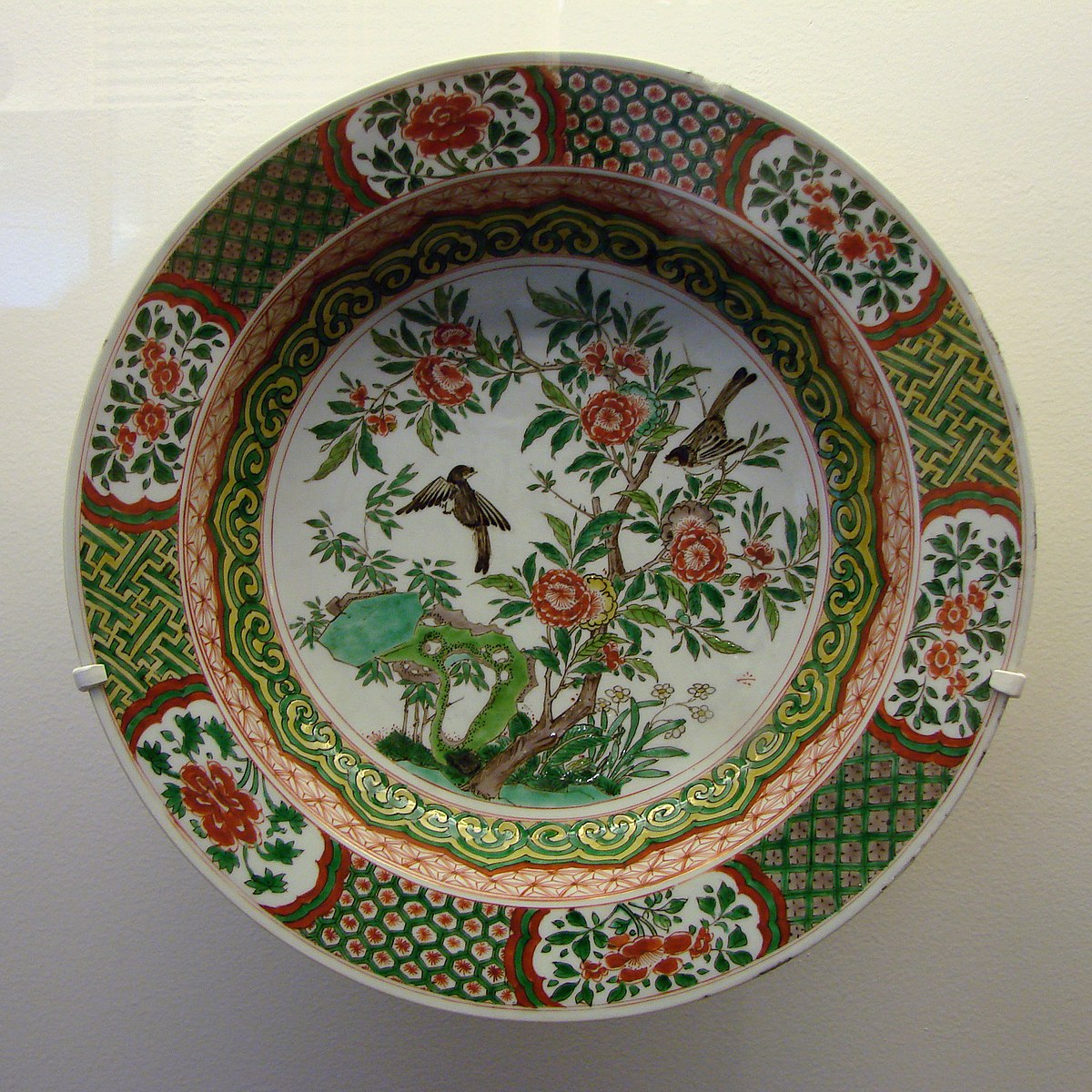 Porcelain plate with birds in flower shrubs