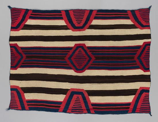 A chiefs blanket with stripes and alternating triangle designs