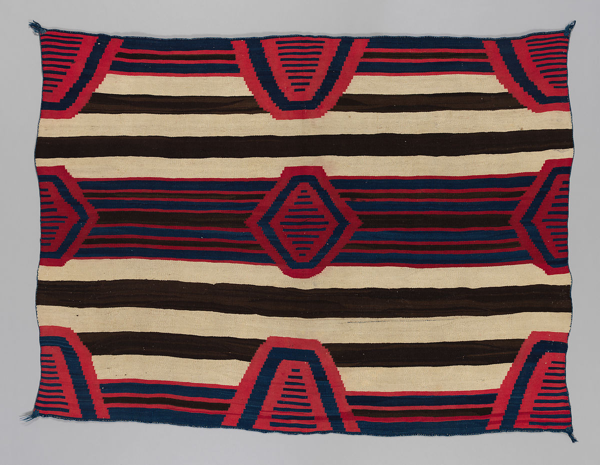 A chiefs blanket with stripes and alternating triangle designs