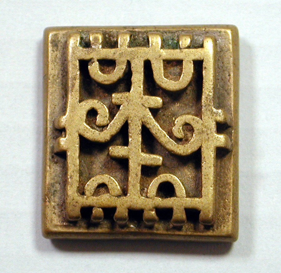 a gold stamp in a square 