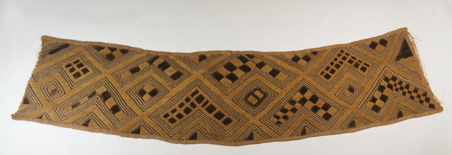 a raffia textile blanket with geometric shapes in yellow and black 