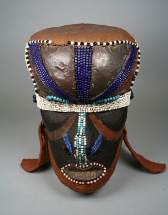 Mask of a face with shells, beads and fabric