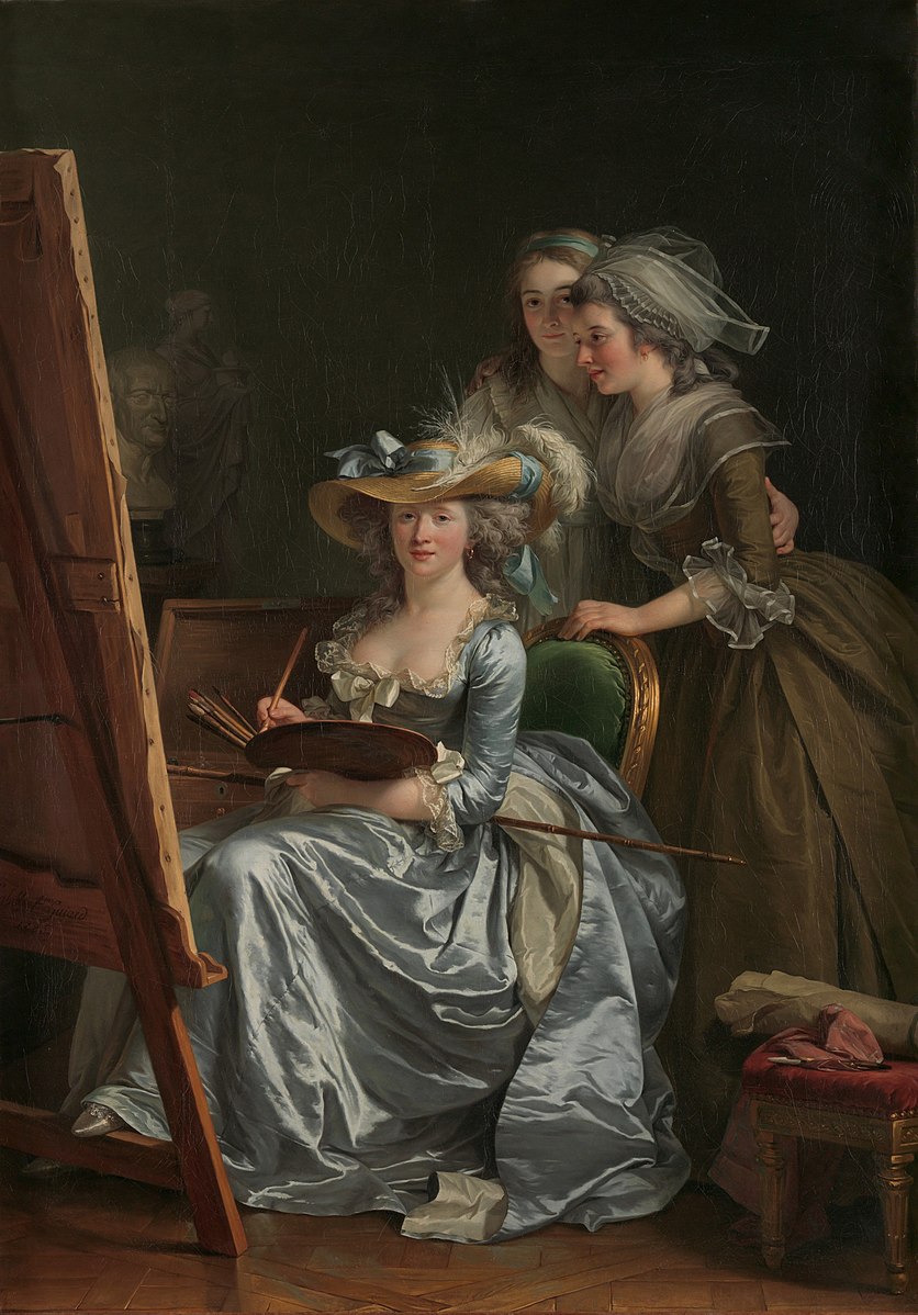 Three women in silk gowns around a canvas while one of them who is seated is painting