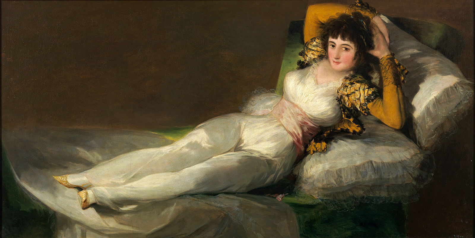 A reclining woman dressed in white linen dress