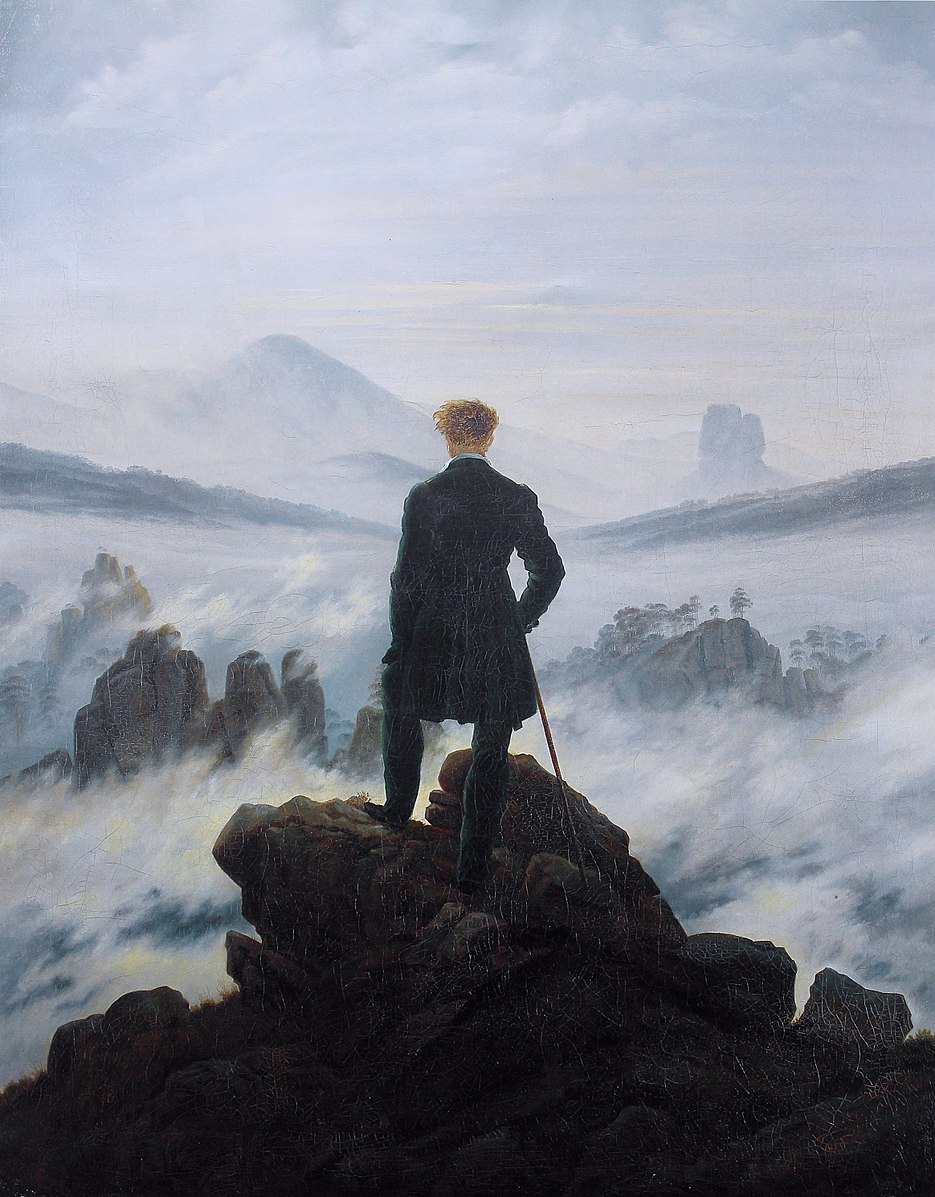 Man in black coat staring at the sea 