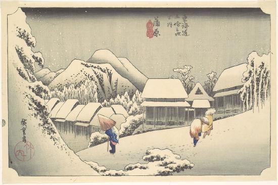Three people walking in the snow in a neighborhood
