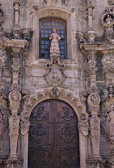 Outside front door of a church built in stone and intricately carved