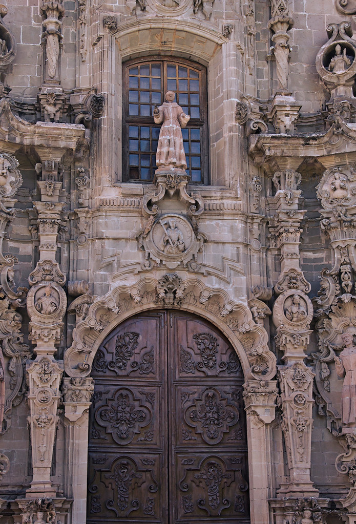 Outside front door of a church built in stone and intricately carved