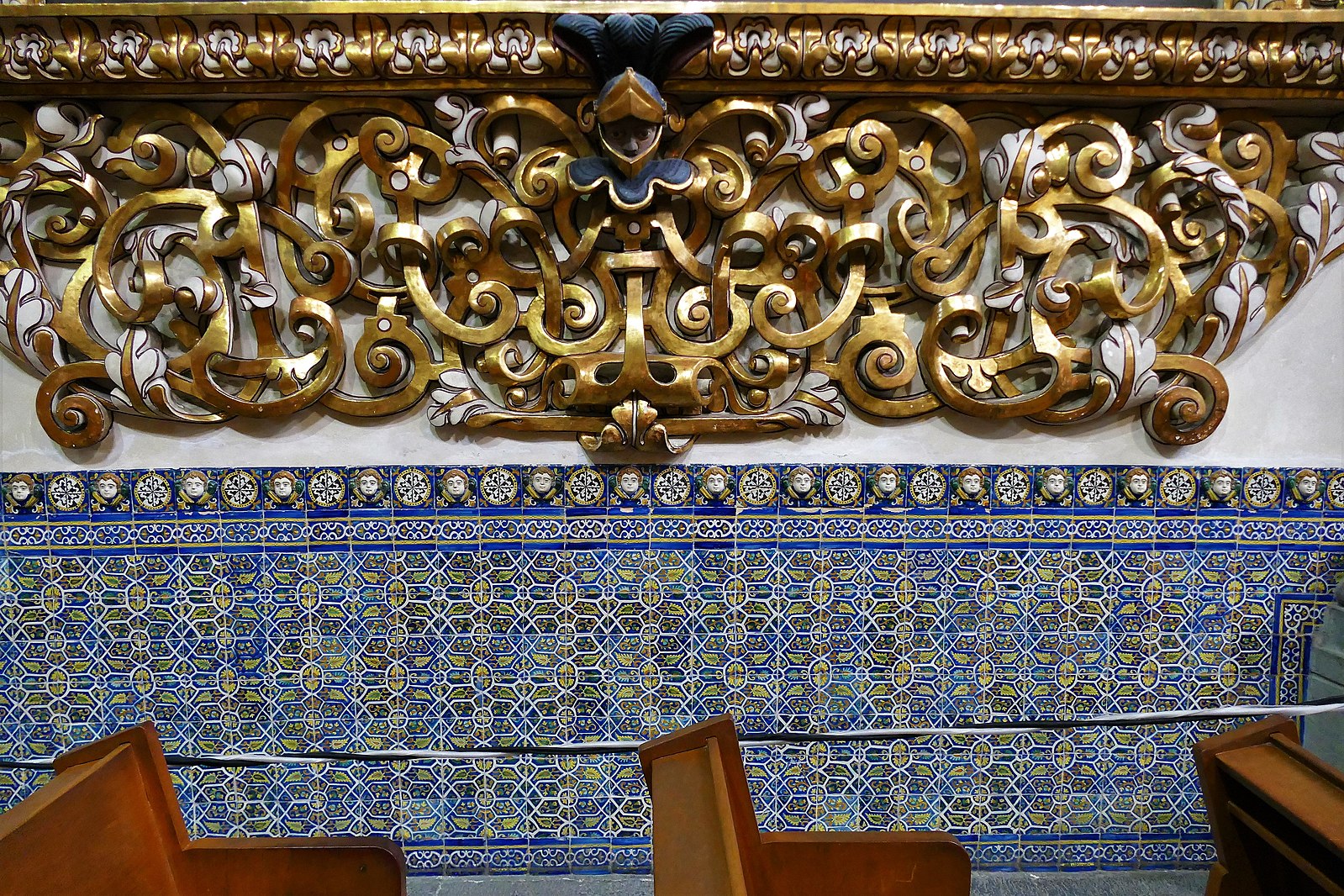 Close up of the wall in the church with mosaic blue tile and the bottom on the scroll work