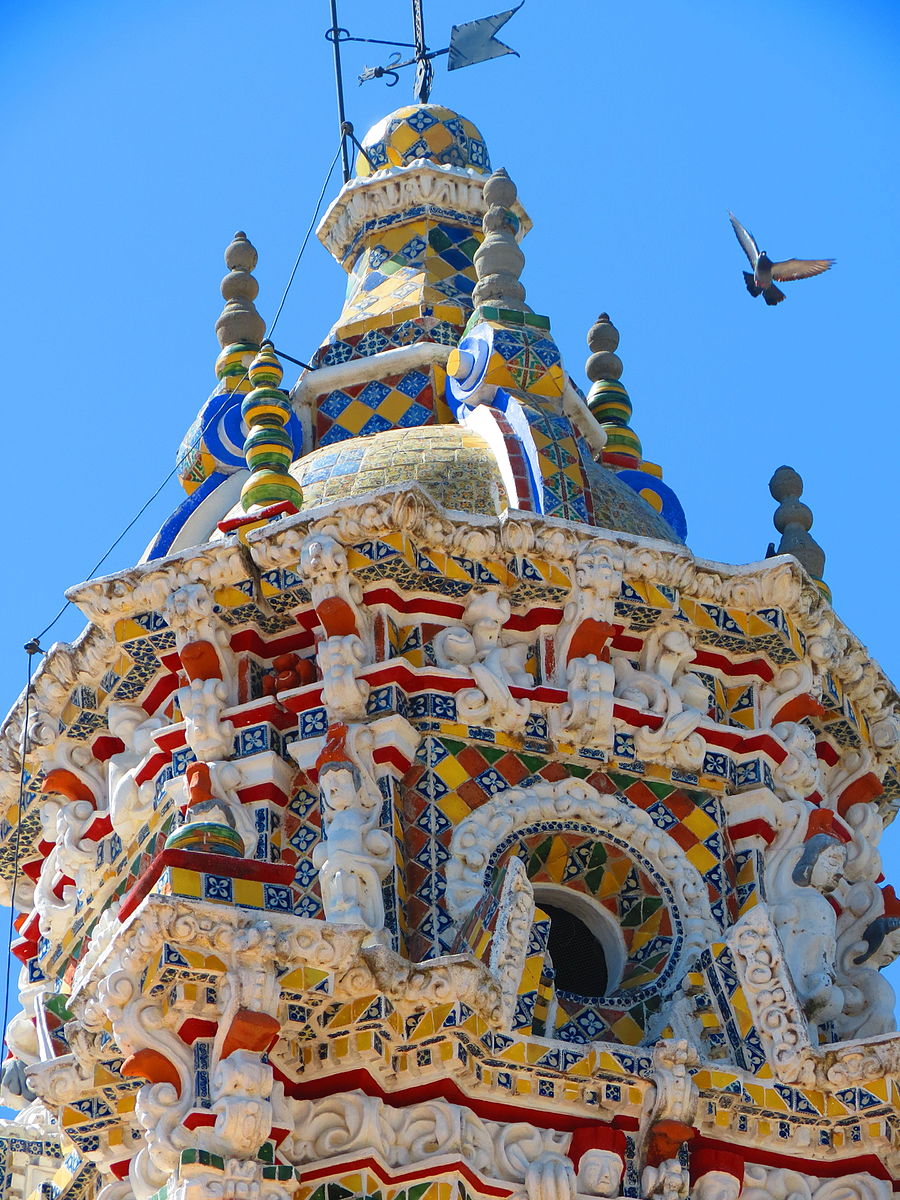 Closeup of the bell towers of a church with colorful tile mosaics
