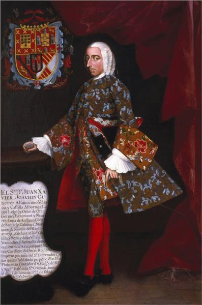 A man standing with a silk colorful suit and bright red socks 