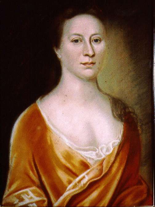 A woman in an orange dress and long brown hair