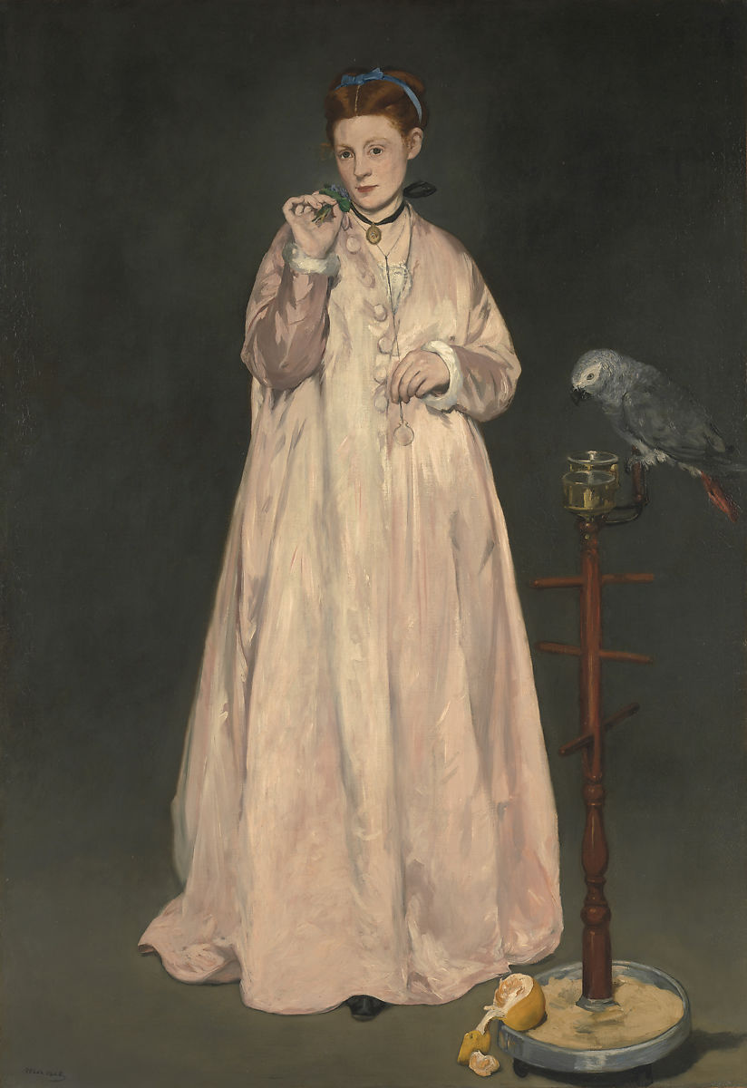 A standing woman wearing a pink dress with a grey parrot