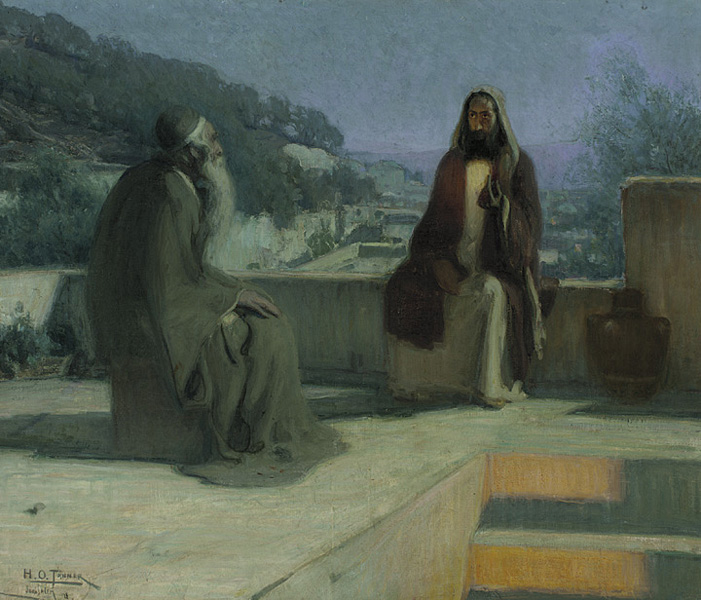 Two men sitting on a stone wall talking