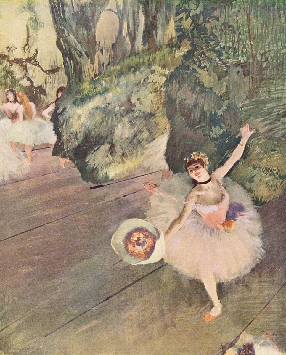 A stage with a ballerina wearing white with flowers in her hand