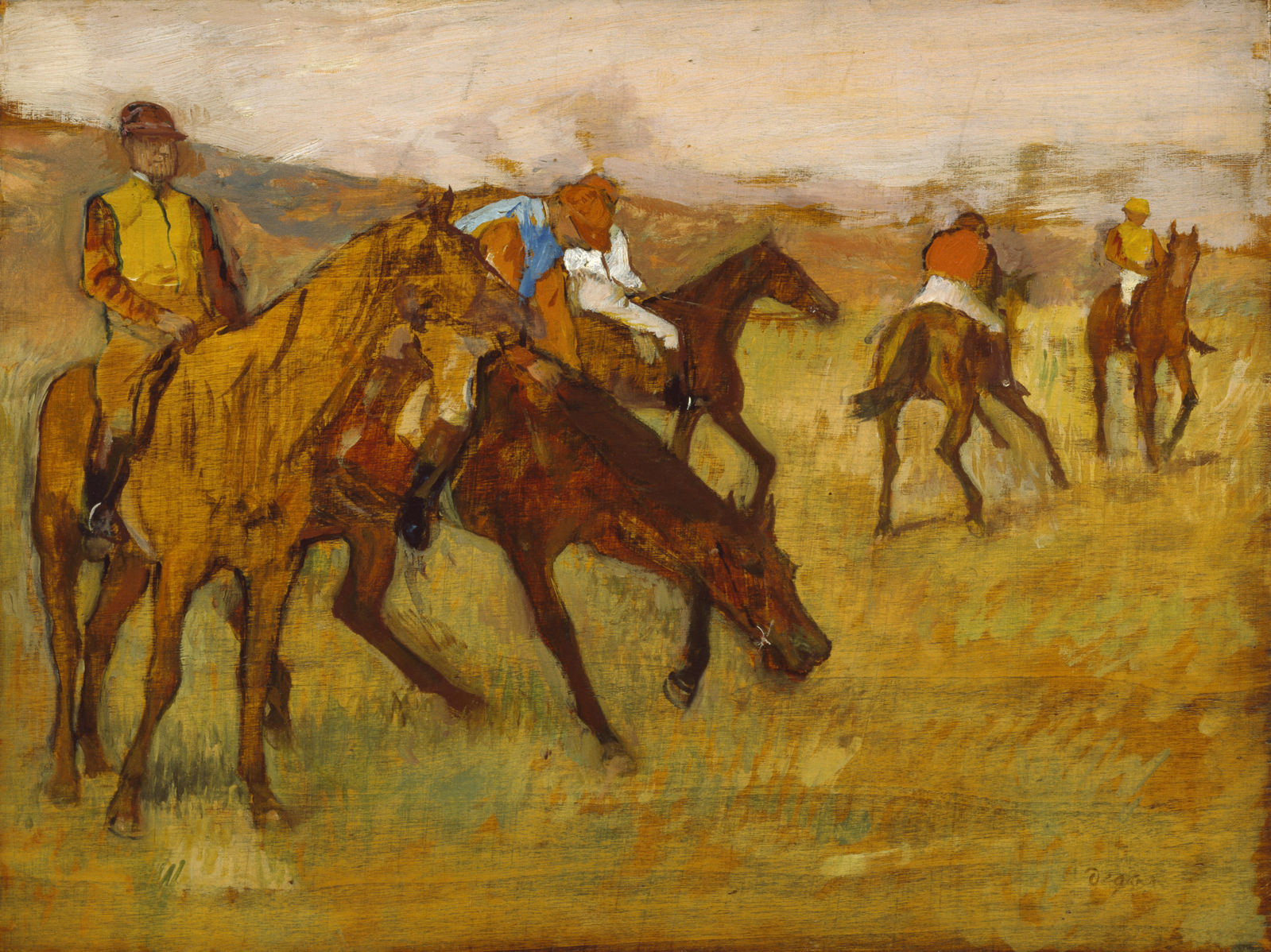 Five horses with jockeys waiting in a field