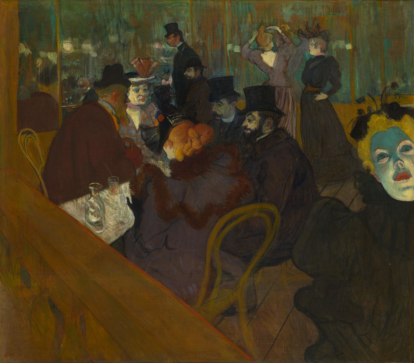 Several people inside a restaurant sitting at a table