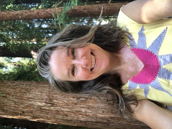 Sarah Sullivan smiling in the redwoods