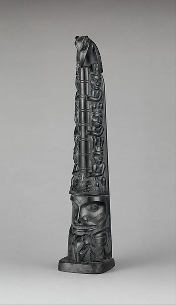 A totem pole carved depicting many animals