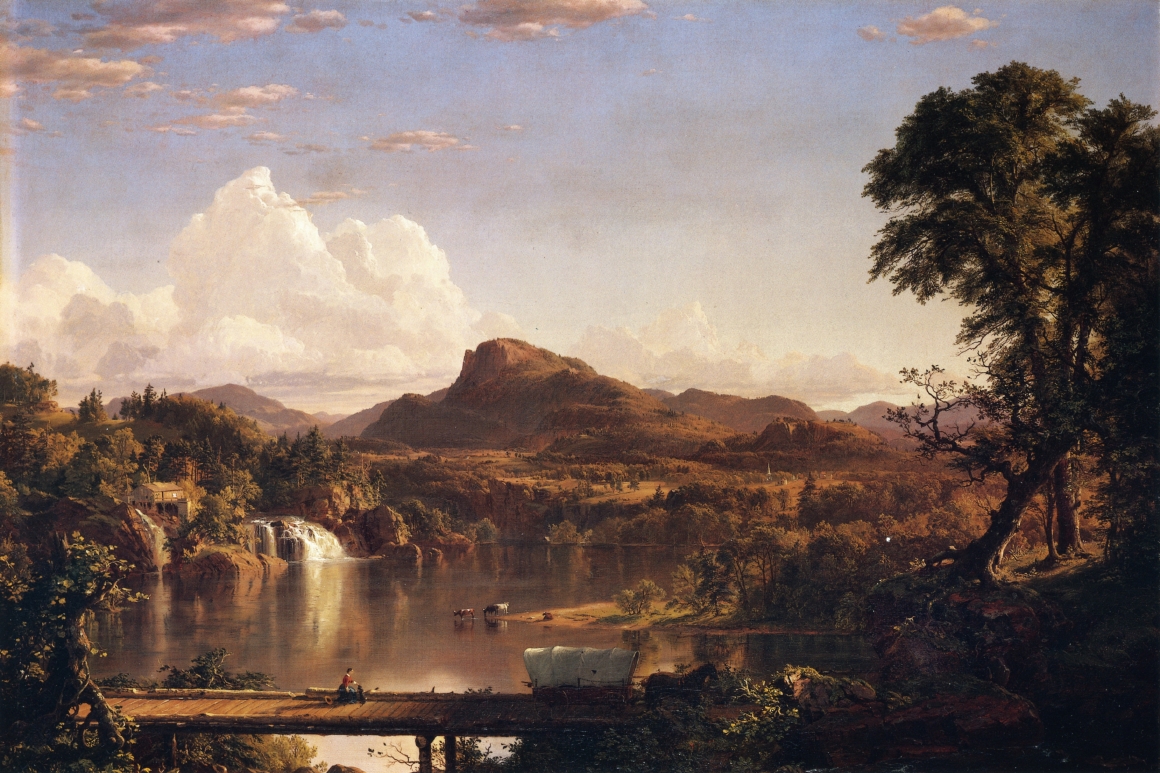A landscape of a lake with mountains and trees