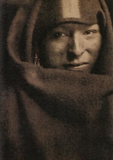 A man wrapped in a blanket with only his face showing
