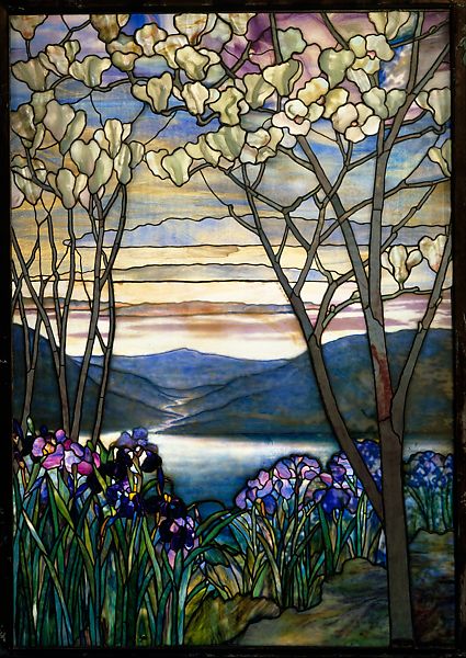 Stained glass window of a landscape of mountains, trees, and a lake