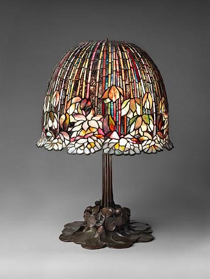 A stained glass lamp shade on a brass lamp