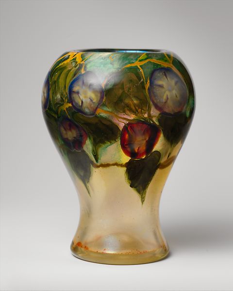 A glass vase with a flower motif