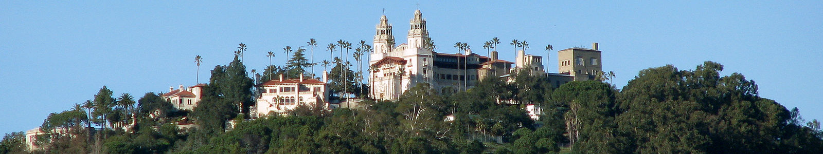 A large stone castle on a hill over looking the California coastline