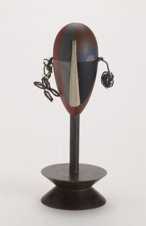 A wooden egg on a stick on a pully