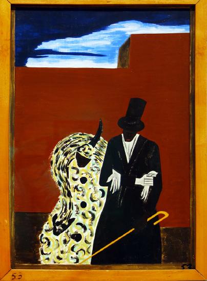 A man in a tux holding a yellow and black person against a red building