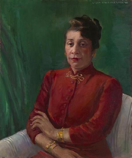 A woman sitting in a chair with a red dress against a green wall