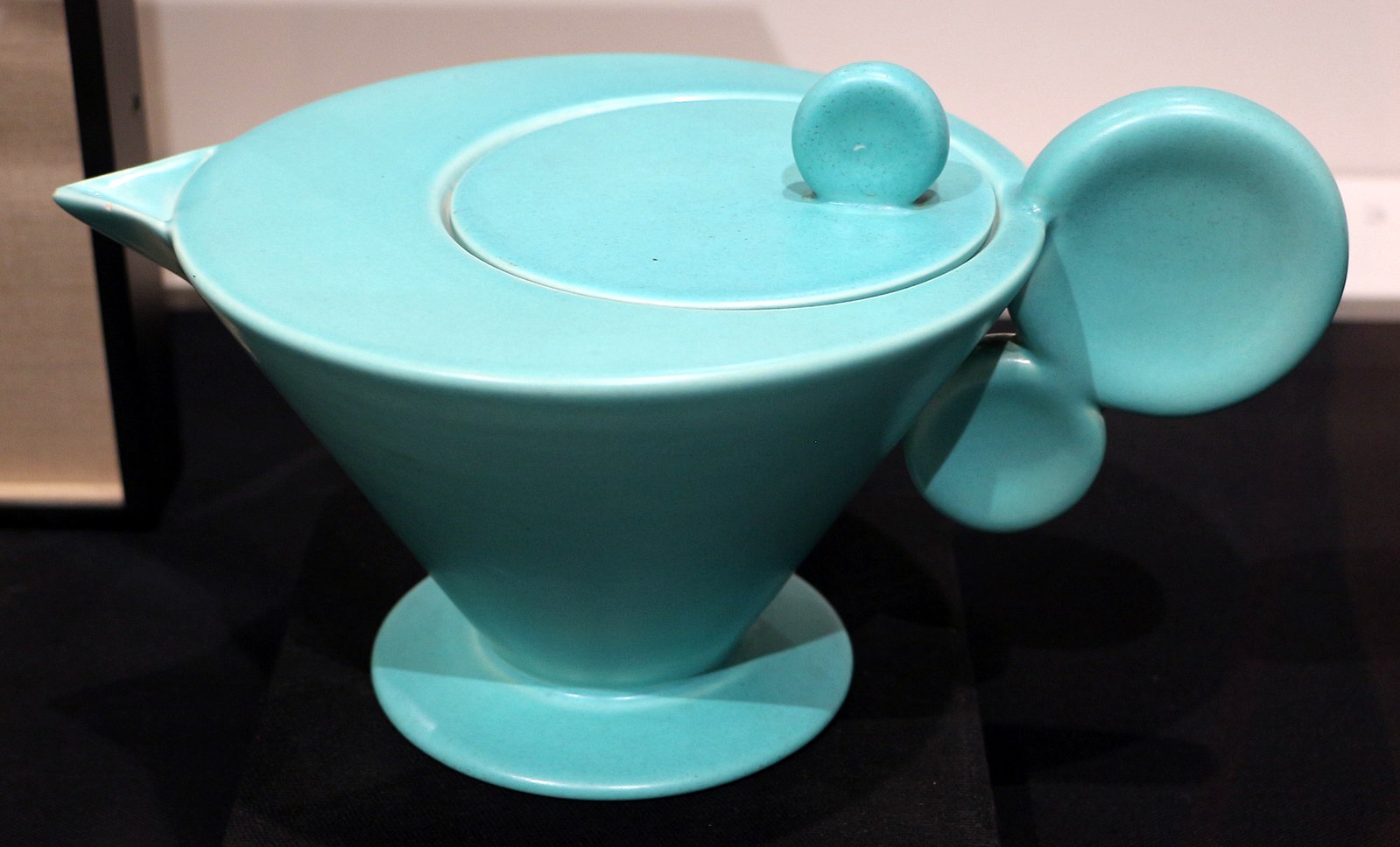 A blue colored teapot made of clay