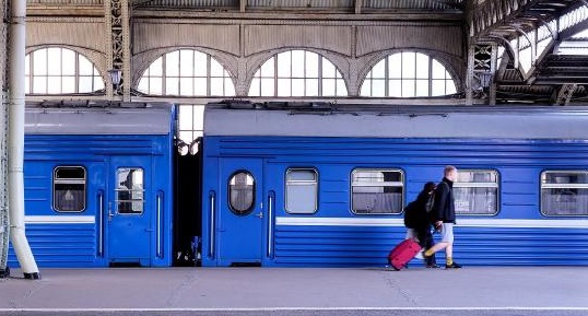A blue train in a station