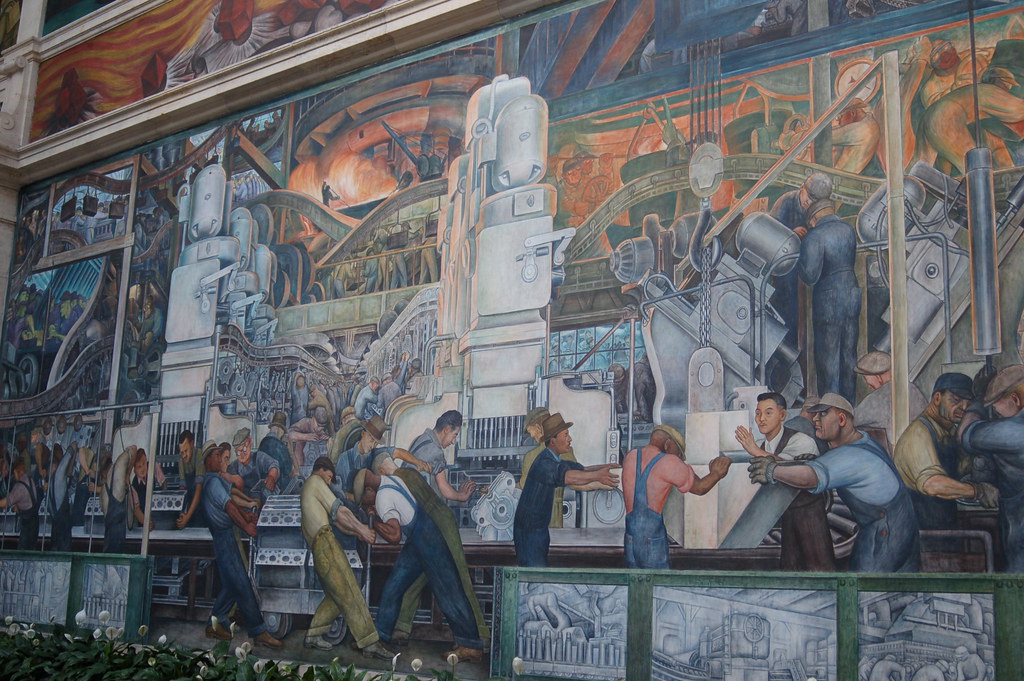 Un mural de hombres trabajando en una fábrica