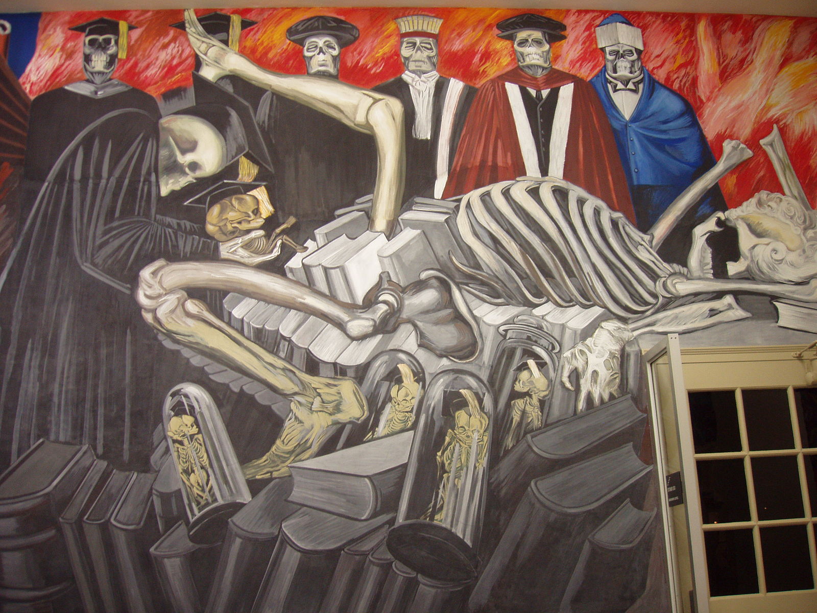 A mural with a large skeleton surrounded by other skeletons