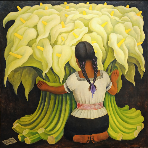 A woman with two braids and a white shirt wraps her arms around a large bundle of lilies