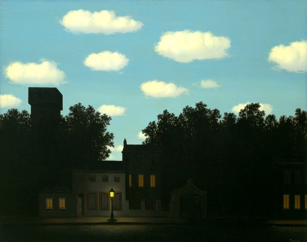 A neighborhood at night with a bright blue sky with cloudes