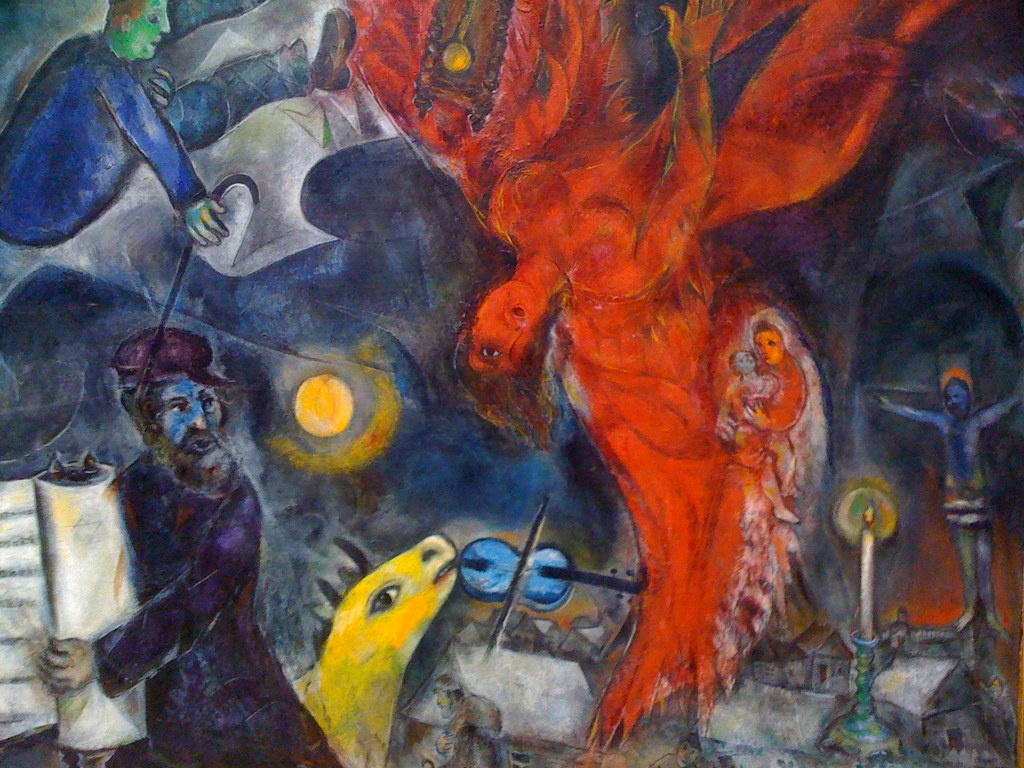 A large red bird like creature with several other people with musical instruments