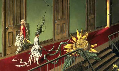 Two people draped in white with long hair standing upright in a green hallway with a large sunflower